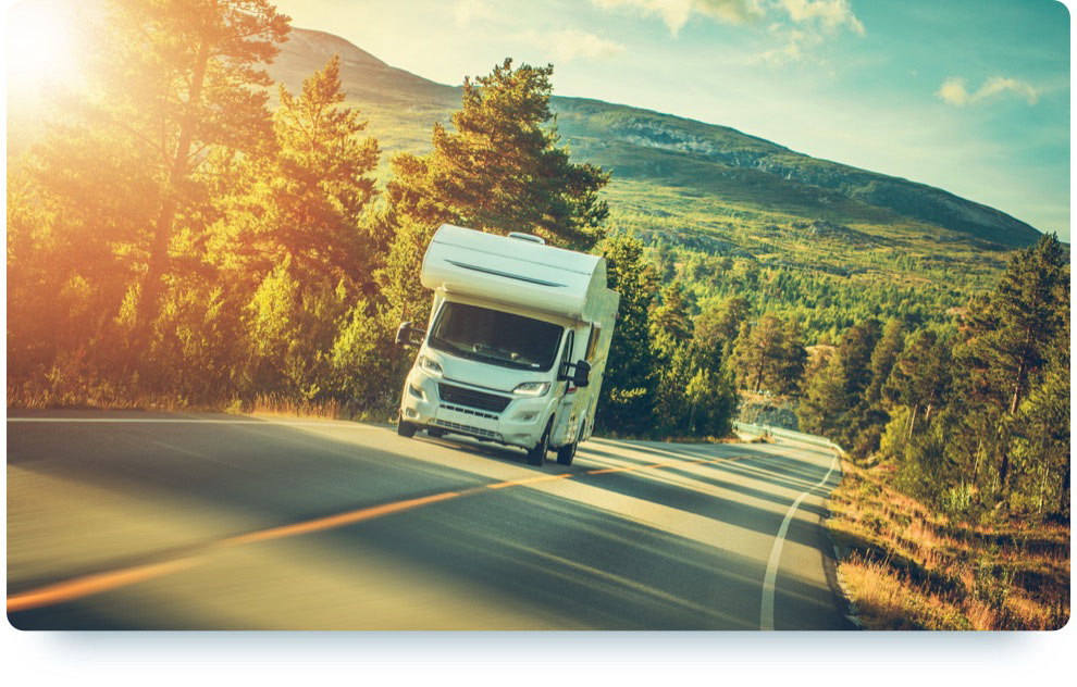 RV Rental driving down the road in the mountains